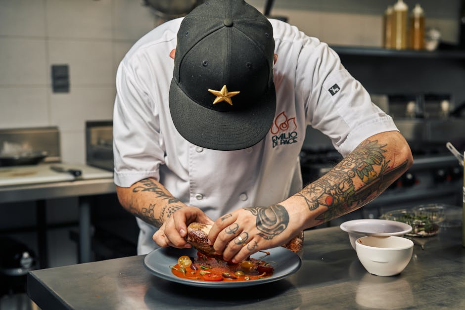 Professional chef plating gourmet food for an event
