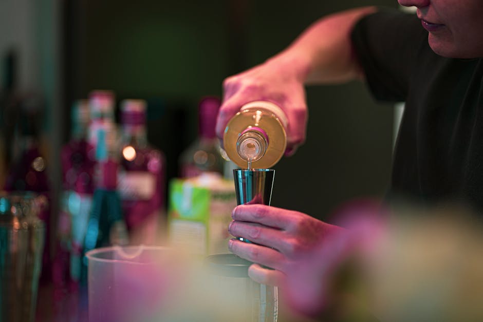 Bartender pouring a signature cocktail at an event
